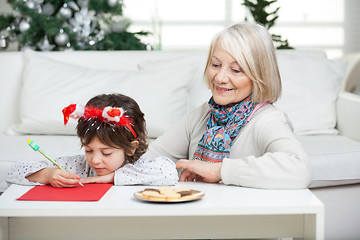 Image showing Grandmother Looking At Boy Writing Letter To Santa Claus