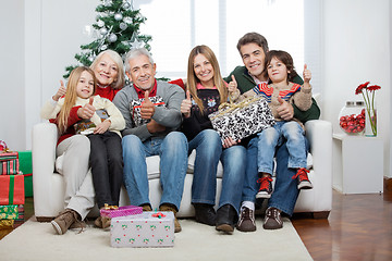 Image showing Family With Christmas Presents Sitting On Sofa