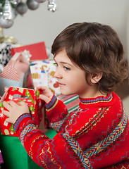 Image showing Boy Stacking Christmas Gifts