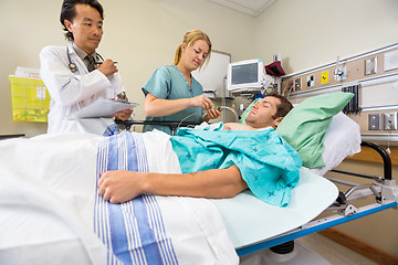 Image showing Doctor And Nurse Examining Patient In Hospital