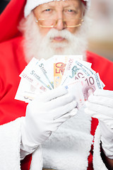 Image showing Santa Claus Holding Money