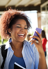 Image showing Female Student Reading Text Message On Mobilephone At Campus