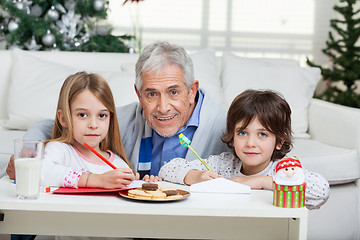 Image showing Grandfather And Children With Cardpapers