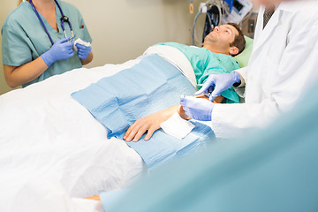 Image showing Doctor Stitching Male Patient's Wound