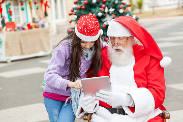 Image showing Girl And Santa Claus Using Digital Tablet