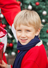 Image showing Cute Boy Receiving Gift From Santa Claus