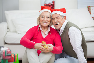 Image showing Smiling Senior Couple Wearing Santa Hats