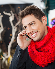 Image showing Man Using Mobilephone In Christmas Store