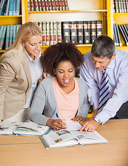 Image showing Teachers Assisting Student In College Library