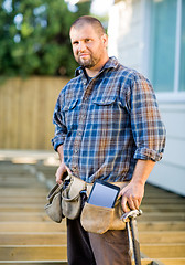 Image showing Carpenter With Digital Tablet And Hammer In Tool Belt At Site