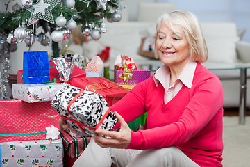 Image showing Senior Woman Looking At Christmas Gift