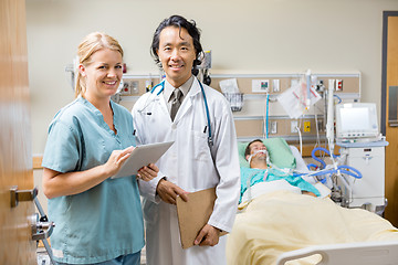 Image showing Nurse And Doctor Examining Patient's Report