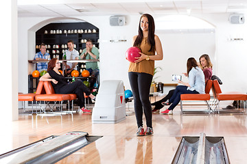 Image showing Woman Holding Ball in Bowling Alley