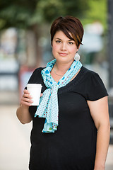 Image showing Woman Holding Disposable Coffee Cup Outdoors