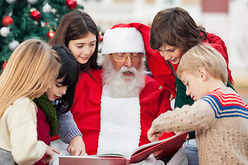 Image showing Children And Santa Claus Reading Book