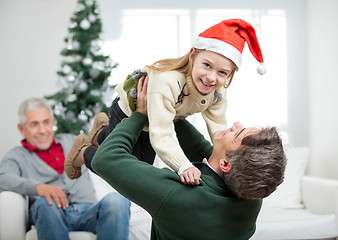 Image showing Daughter Being Carried By Father During Christmas