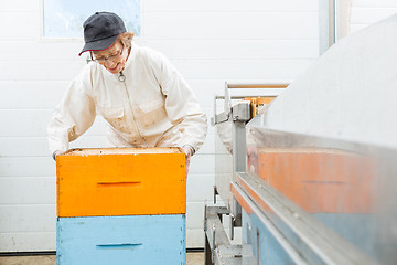 Image showing Beekeeper With Honeycomb Crates At Factory