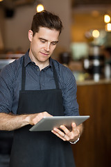 Image showing Male Owner Using Digital Tablet
