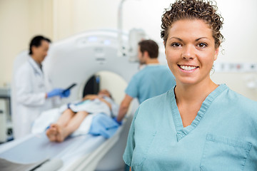 Image showing Nurse With Colleague And Doctor Preparing Patient For CT Scan