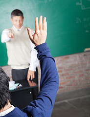 Image showing Student Raising Hand To Answer Question In Classroom