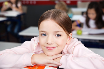 Image showing Schoolgirl Resting Chin On Hands In Classroom