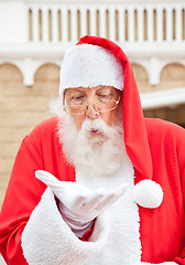 Image showing Santa Claus Blowing In Palm