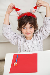 Image showing Boy With Cardpaper And Pencil Holding Santa Headband