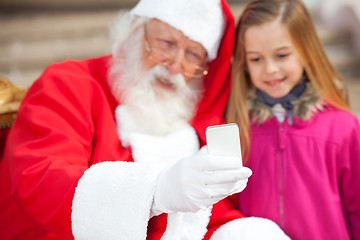 Image showing Santa Claus And Girl Taking Selfportrait Through Smartphone
