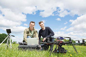 Image showing Men Using Laptop Next To UAV