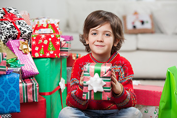 Image showing Smiling Boy Holding Christmas Gift At Home
