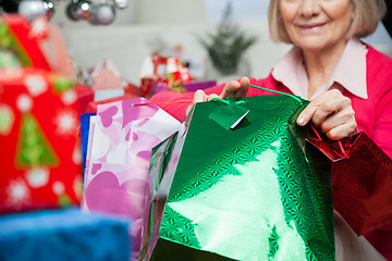 Image showing Senior Woman Holding Bags During Christmas