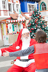 Image showing Boy And Santa Claus About To Embrace