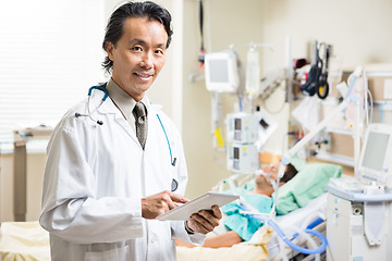 Image showing Doctor With Digital Tablet Examining Patient's Test Report