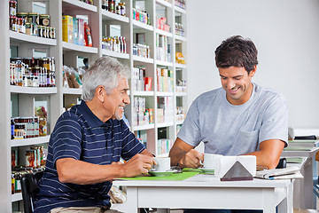 Image showing Father And Son Having Coffee At Table