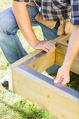 Image showing Manual Worker Measuring Wood With Scale At Construction Site