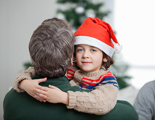 Image showing Son Embracing Father During Christmas