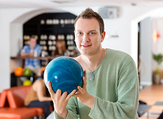 Image showing Man Holding Blue Bowling Ball in Club