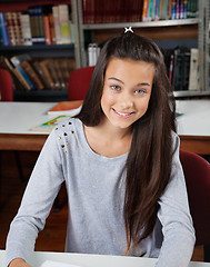 Image showing Happy Female Student Sitting In Library