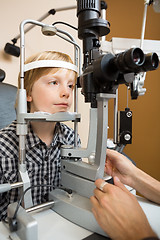 Image showing Boy Having His Eyes Examined With Slit Lamp By Doctor