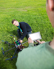 Image showing Engineers Working On UAV Helicopter At Park