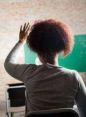 Image showing Female Student Raising Hand To Answer In Classroom