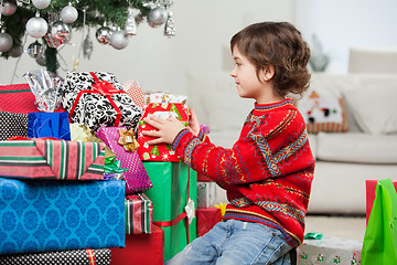 Image showing Boy Stacking Christmas Presents