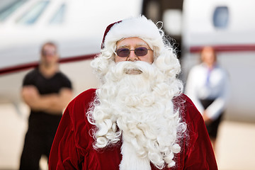 Image showing Santa Standing Against Private Jet