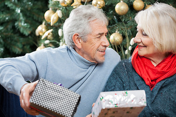 Image showing Senior Couple With Presents In Christmas Store
