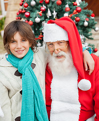 Image showing Happy Boy With Arm Around Santa Claus