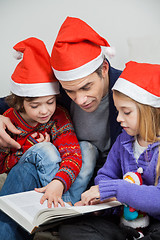 Image showing Children And Father Reading Book