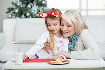 Image showing Grandmother Assisting Girl In Writing Letter To Santa Claus