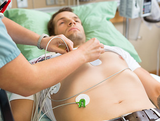 Image showing Nurse Sticking Holter On Patient's Chest In Hospital