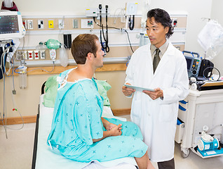 Image showing Doctor Holding Digital Tablet While Discussing Report With Patie