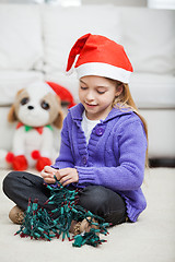 Image showing Girl With Fairy Lights During Christmas